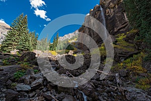 Girl taking picture of Bridal Veil Falls Telluride Colorado USA