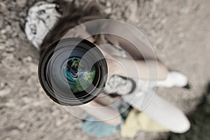 Girl taking pictures lying on the ground