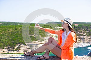 Girl taking pictures on a phone in Bonifacio