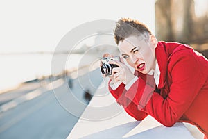 Girl taking pictures on the waterfront at sunset