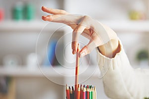 Girl taking red pencil