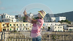 Girl taking selfie with smart phone in vacation