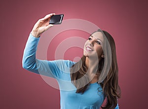 Girl taking selfies with her mobile