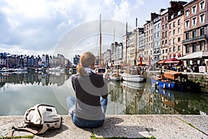 girl taking a shot of Honfleur harbor