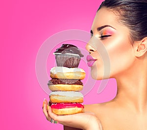 Girl taking sweets and colorful donuts