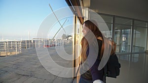 Girl taking viewer by hand and walking in building