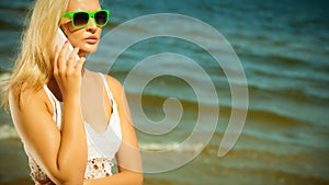 Girl talking on mobile phone on beach