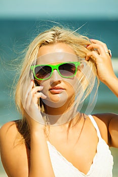 Girl talking on mobile phone on beach