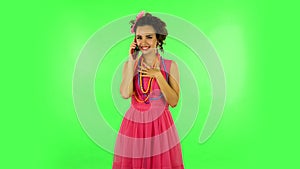 Girl talking for mobile phone, very shocked and rejoices. Green screen