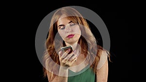 Girl talking on the phone. Black background. Slow motion