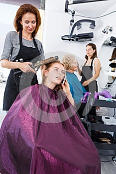 Girl talking on phone in hair salon