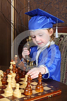 Girl talking on the phone while playing chess
