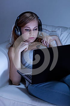 Girl talking on skype on couch photo