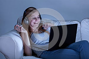 Girl talking on skype at night photo