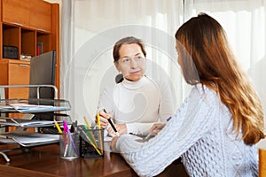 Girl talking to employee with computer
