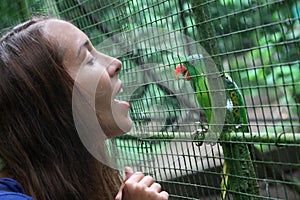 Girl talking to the parrot