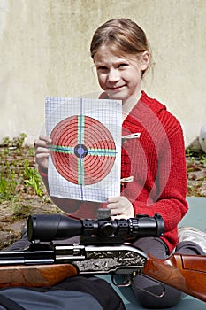 Girl with a target and a pneumatic gun