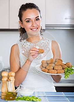 Girl with tasty breadcrumbed crocchette photo