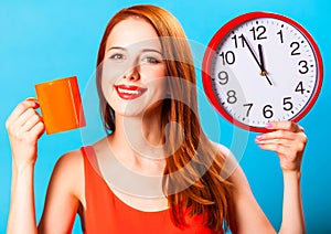 Girl with tea cup and huge clock