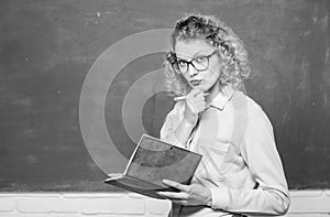 girl teacher at private lesson. concentrated student in glasses at blackboard. essay writing. teacher with notebook