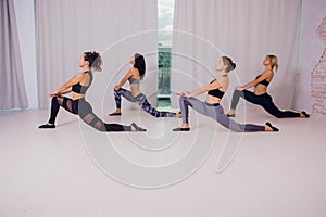 Girl teaches Yoga young in the Studio