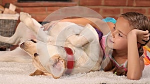 Girl teasing her beloved labrador dog