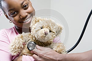 Girl and teddy with stethoscope