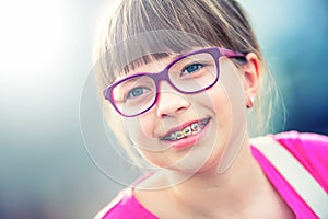 Girl. Teen. Pre teen. Girl with glasses. Girl with teeth braces. Young cute caucasian blond girl wearing teeth braces and glasses