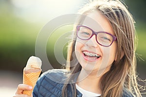 Girl. Teen. Pre teen. Girl with ice cream. Girl with glasses. Girl with teeth braces.