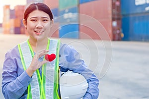 Girl teen worker in cargo container shipping port working with heart and good service mind concept