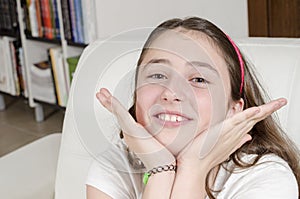 Girl teenage brunette is looking at camera with smile.