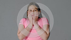 Girl teenager on a gray background depicts emotions