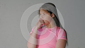 Girl teenager on a gray background depicts emotions