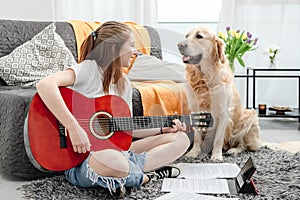 Girl teenager practicing guitar playing