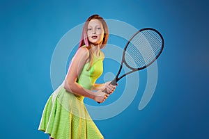 girl teenager with racket in sporswear and hat photo