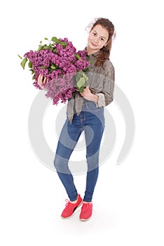 Girl teenager standing with lilac in hands