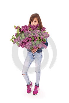 Girl teenager standing with lilac in hands