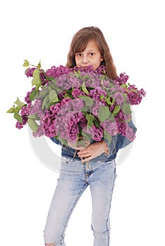 Girl teenager standing with lilac in hands