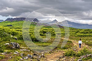 Girl teenager on the walk pass to Eldborg volcano crater in Vesturland region of Iceland photo