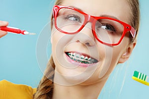 Girl with teeth braces using interdental and traditional brush