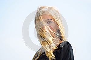 Girl tender blonde makeup face sky background. Bleaching roots. How to repair bleached hair fast and safely. How to take