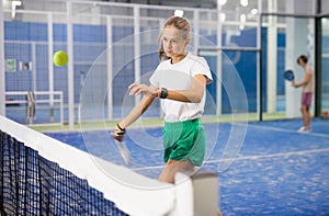Girl tennis player playing padel tennis