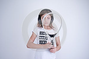 Girl with tennis racket looking right photo