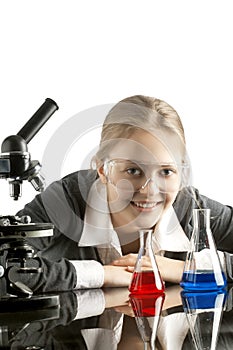 Girl with test tubes and microscope for chemical class