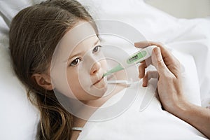 Girl With Thermometer In Mouth photo