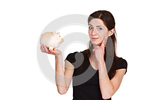 Girl thinks about saving money with moneybox