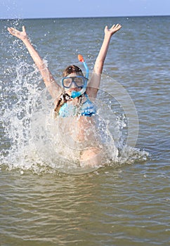 Girl of thirteen in a mask for diving into the sea