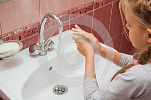 Girl thoroughly wash their hands with soap