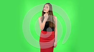 Girl threatens with a fist. Green screen