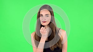 Girl threatens with a fist. Green screen